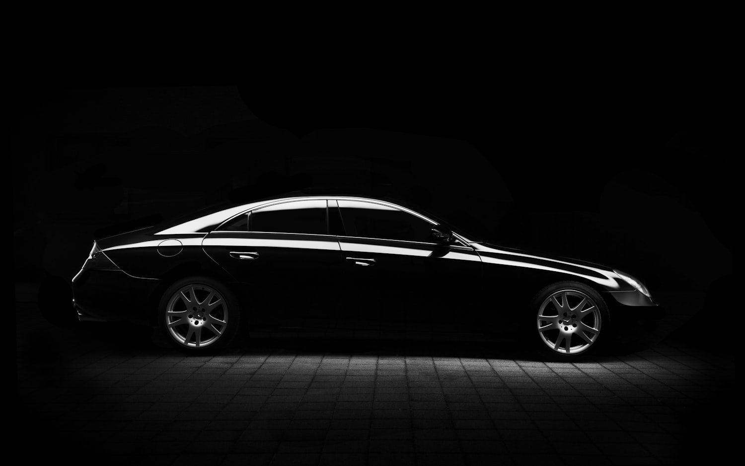 A glossy black car detailed to a showroom-quality finish