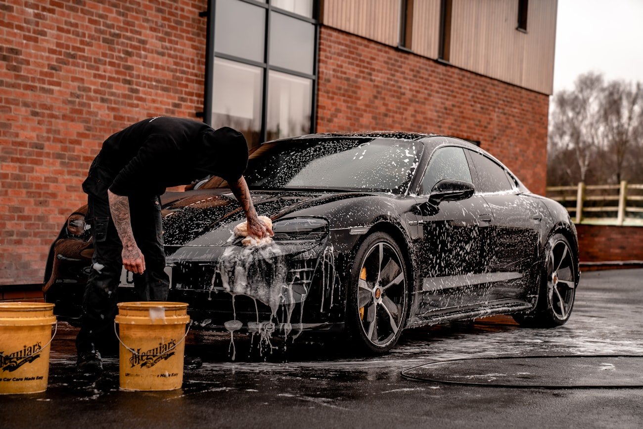 A car being foam-washed in a detailing bay
