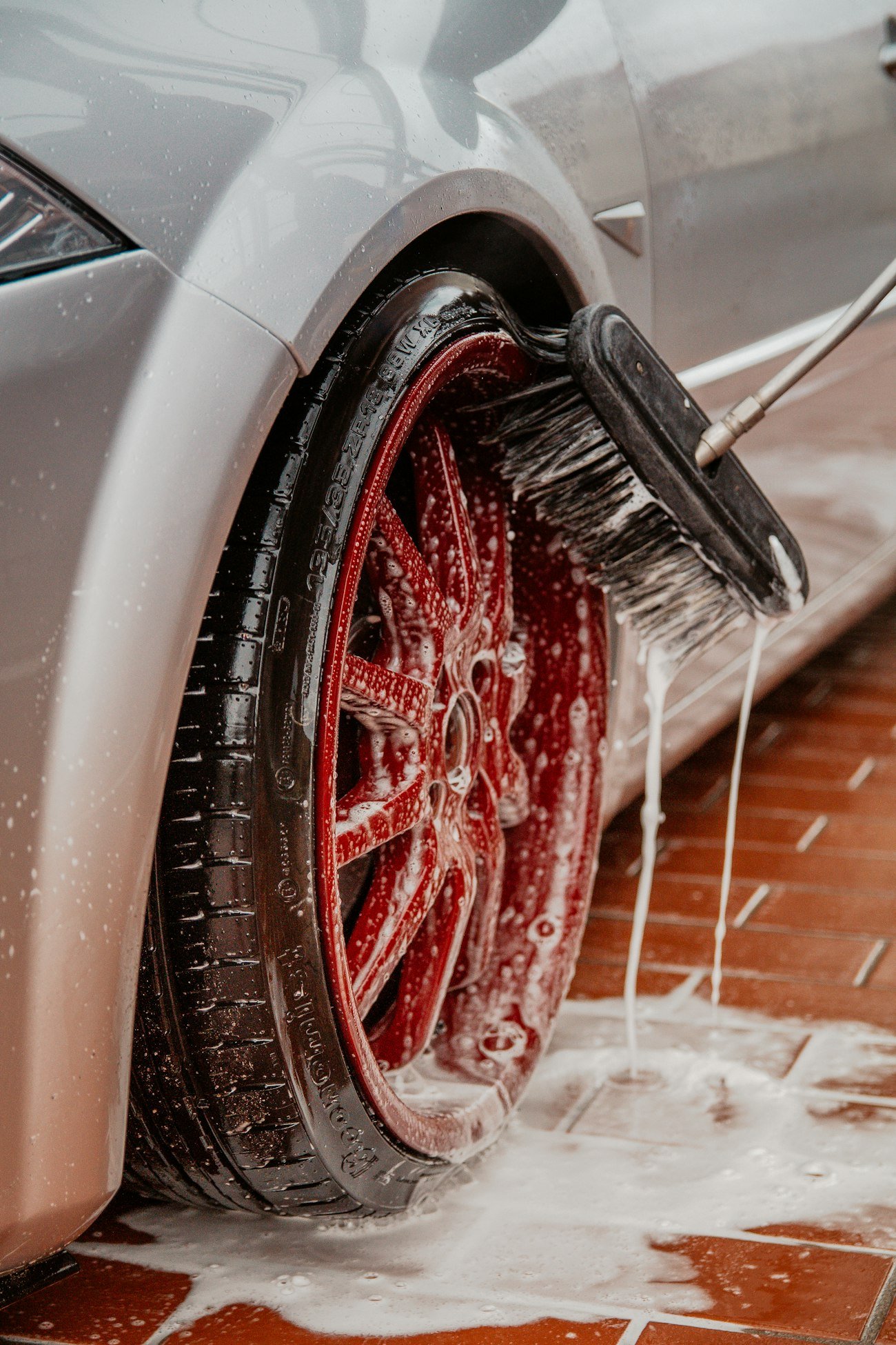 A wheel and brake caliper being deep-cleaned